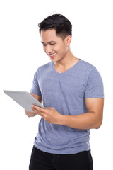 Young Asian man holding a digital touch screen tablet computer o