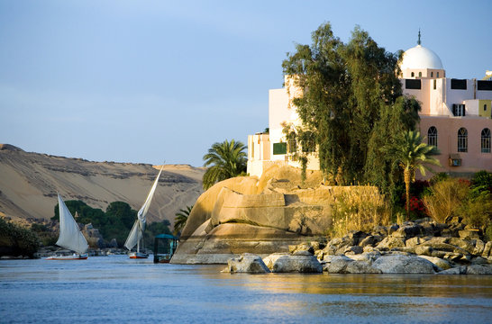 Egypt, Aswan, feluccas sailing on the Nile river in the town outskirts