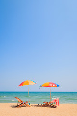 Fototapeta na wymiar Blurred image of beach chair and umbrella on sand beach