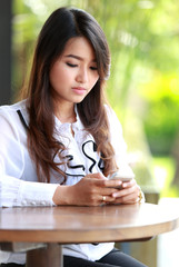 young woman texting while waiting