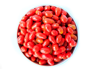 Group of tomatoes in bowl on white background