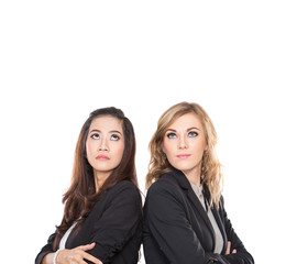 Two young businesswoman leaning againts each other, isolated. lo