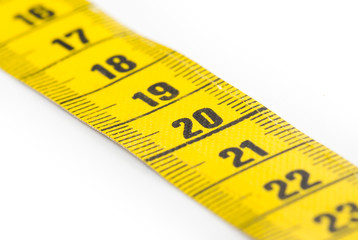 Yellow measuring tape isolated - selective focus