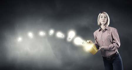 Girl splashing light bulb from bucket