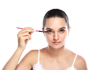 beautiful woman applying some mascara