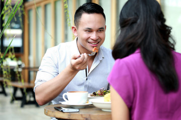 Fototapeta na wymiar handsome man having lunch with his girlfriend