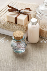 Obraz na płótnie Canvas Bar of handmade soap, bottle of essential oil and bottle of liqu