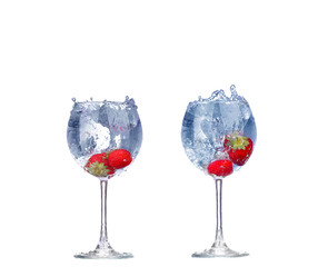 collage  Strawberry splash in a cocktail glass on white