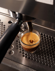 Hot coffee flow to a cup on espresso machine