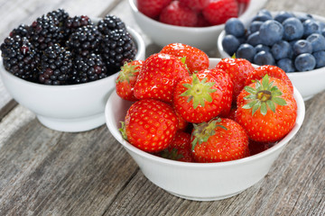 strawberries in a bowl and fresh garden berries