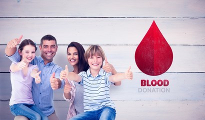 Composite image of happy family gesturing thumbs up