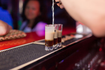 The bartender makes a cocktail shot