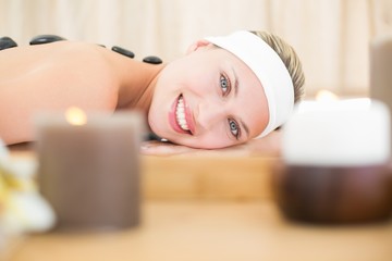 Obraz na płótnie Canvas Beautiful blonde enjoying a hot stone massage 