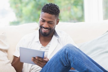 Man using his tablet on couch