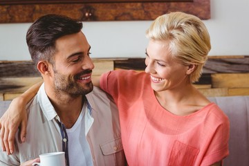 Happy couple hugging and smiling at each other