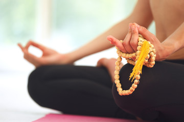 Young woman meditating in lotus pose.