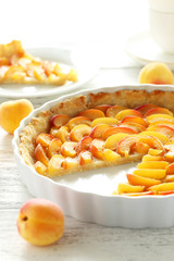 Apricot pie on white wooden background