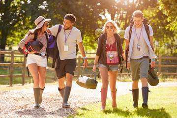 Group Of Young People Going Camping At Music Festival
