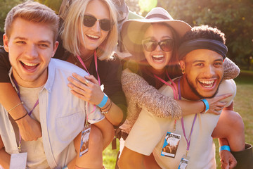 Men Giving Woman Piggybacks On Their Way To Music Festival