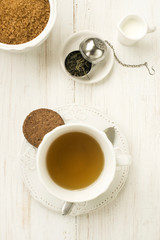 cup of tea with milk  sugar and cookie