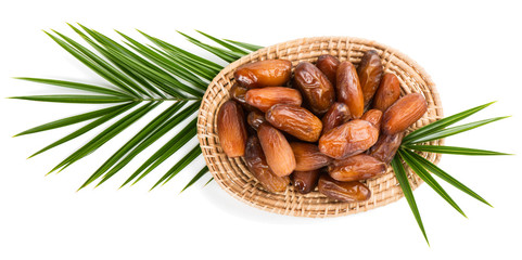 Wicker tray of date fruits, shot from above