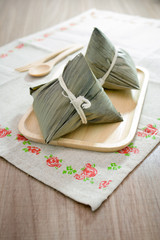 Asian Chinese rice dumplings or zongzi on wooden background
