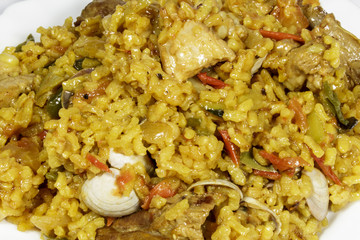 Dish of paella rice with meat and clams