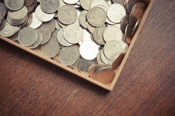 coins on wood with filter effect retro vintage style