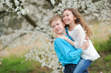 Portrait of a boy and girl in the lush garden