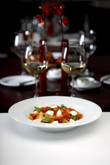 Tagliatelle in a tomato sauce with mozzarella and mint, Italian pasta, shallow depth of field, studio shot