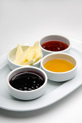 Stylish breakfast with jam, honey and butter served