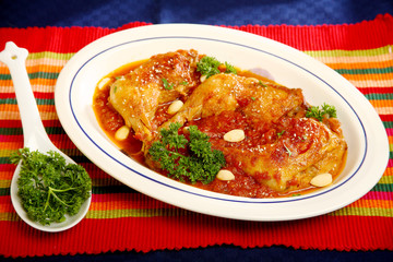 Turkey legs in red sauce with spices and pine nuts