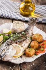 Baked fish dorado with vegetables