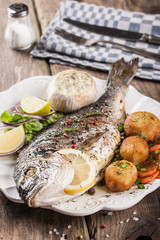 Baked fish dorado with vegetables