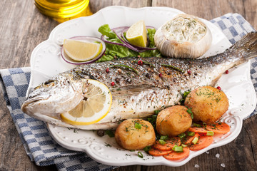 Baked fish dorado with vegetables