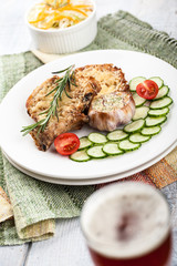 Dish of fried pork chops and glass of beer