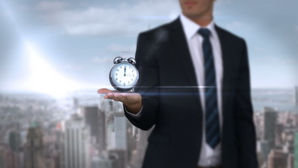 Businessman holding alarm clock - Powered by Adobe