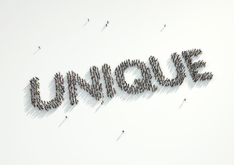 Aerial shot of a crowd of people gathered together to form the word 'Unique'. Concept for how every person is different in their personality and looks and yet we are all the same.