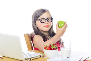 a pretty little girl with long hair eats an apple