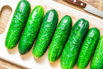 Fresh cucumbers on the cutting board in the drops of water