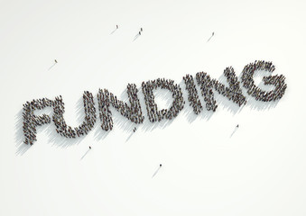 Aerial shot of a crowd of people forming the word Funding Concept for crowd funding platforms or projects that are supported financially by crowd funded websites.