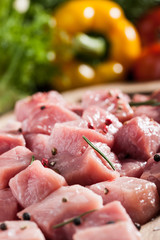 Raw pork  on cutting board and fresh vegetables