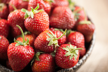 Red fresh strawberry in ceramic bowl