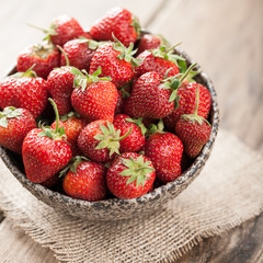 Red fresh strawberry in ceramic bowl