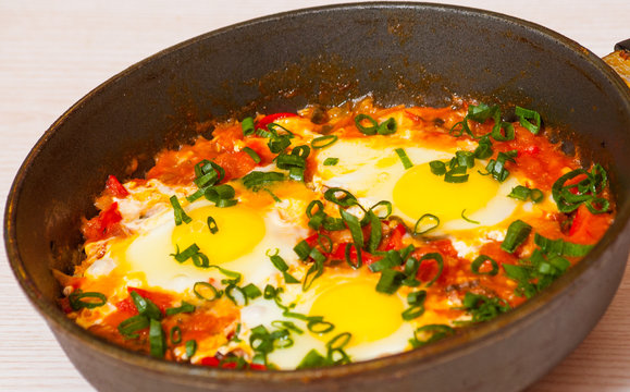 eggs with vegetables in a frying pan