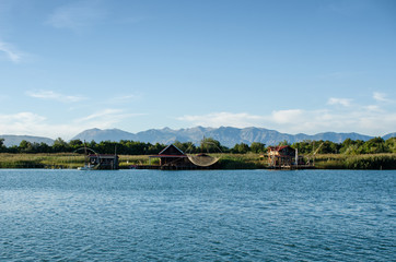 Fototapeta na wymiar Fishing cabins at a river