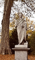 Stuttgart Germany -  Schiller statue at Schloss park on autumn with fallen leaves