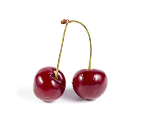 A pair of ripe cherries isolated on white