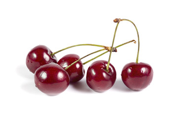 Five ripe cherries isolated on white