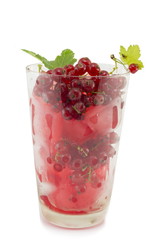 Currant ice tea in a glass with fresh currant isolated